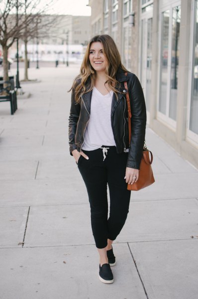 Leather jacket with a white V-neck t-shirt and black jogger jeans