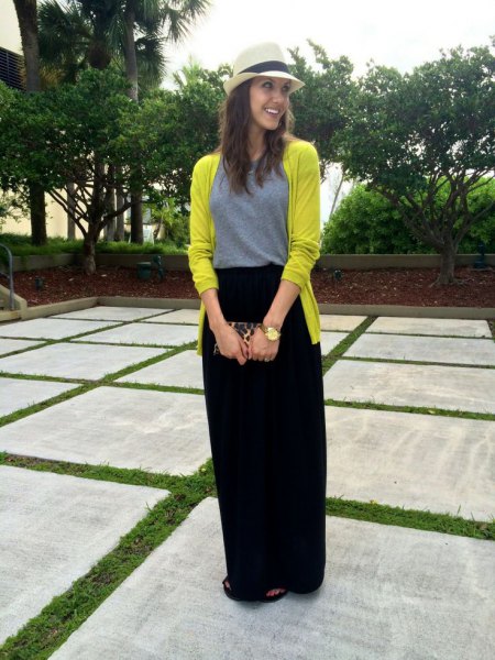 Lemon yellow cardigan with a black maxi travel skirt with a relaxed fit