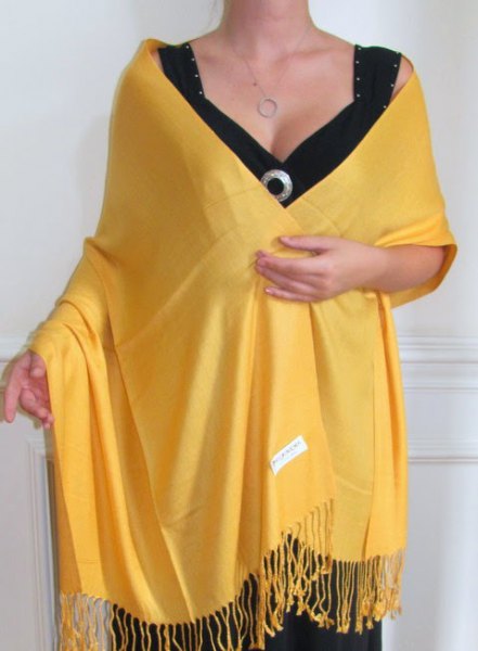 Lemon yellow fringed scarf with black midi dress with deep V-neck