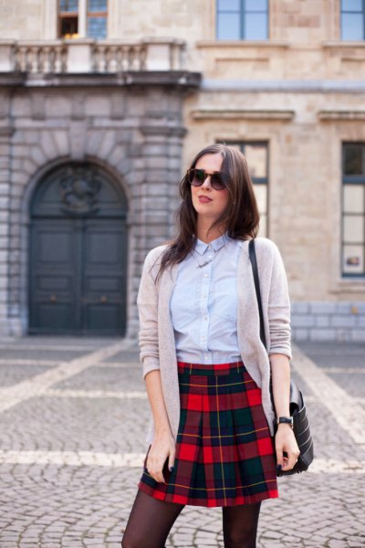 light blue shirt with buttons, gray cardigan and black checked mini skirt