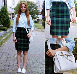 light blue shirt with buttons and dark blue and green checked pencil skirt