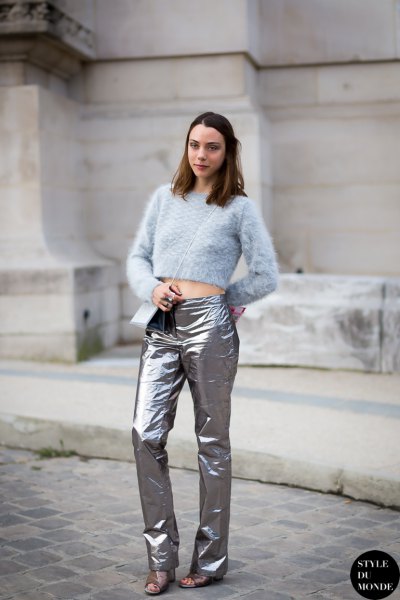 Light blue, cropped knitted sweater with silver trousers and sandals