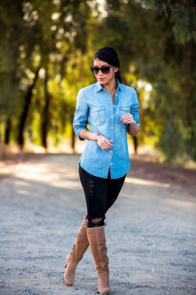 Light blue denim shirt with black jeans and knee-high boots with camel heels