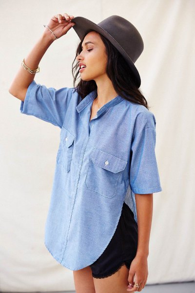 Light blue chambray shirt with a side slit and black mini shorts