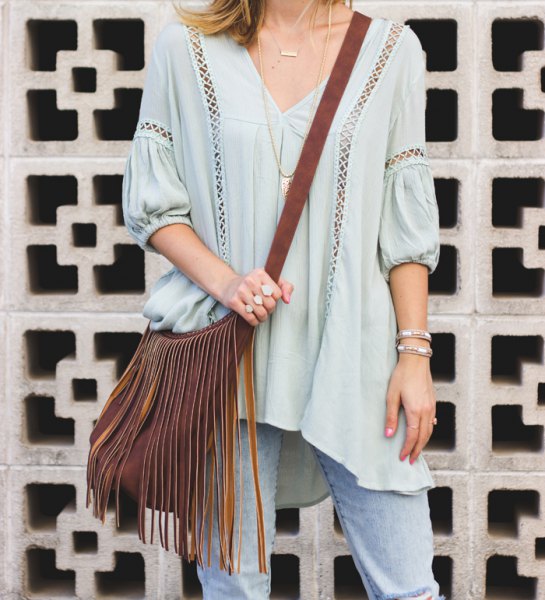 Light blue tunic top with V-neck and V-neck and small cutouts