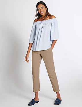 Light blue strapless blouse with beige, narrow-cut chinos