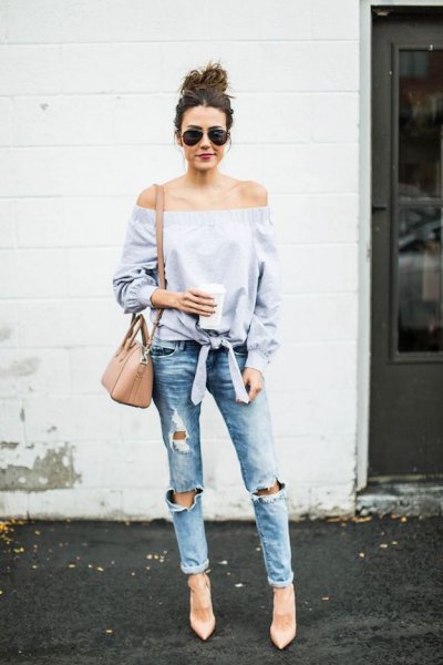 Light blue, off-the-shoulder, knotted blouse with ripped boyfriend jeans