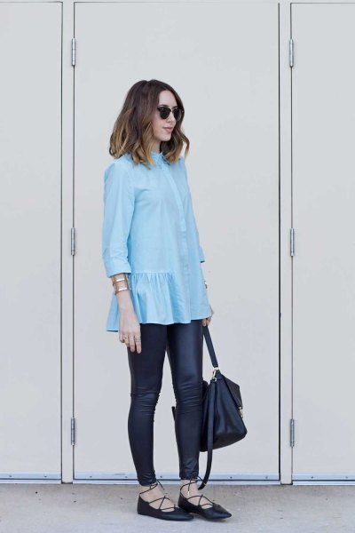 light blue blouse with frilled hem and black leather gaiters