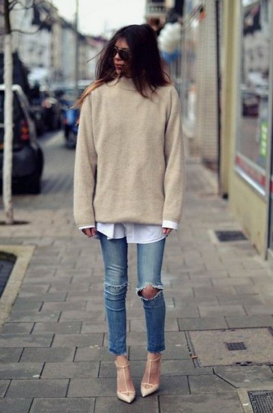 Light gray, chunky sweater with a stand-up collar and a white shirt with buttons