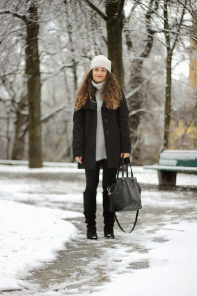 light gray sweater dress with down jacket and black knee-high snowshoes