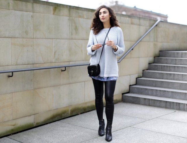 Light gray sweater over tie-dye tunic top and leather gaiters