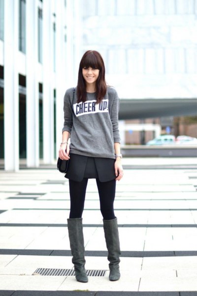Light gray sweater with black wrap skirt and over-the-knee suede boots
