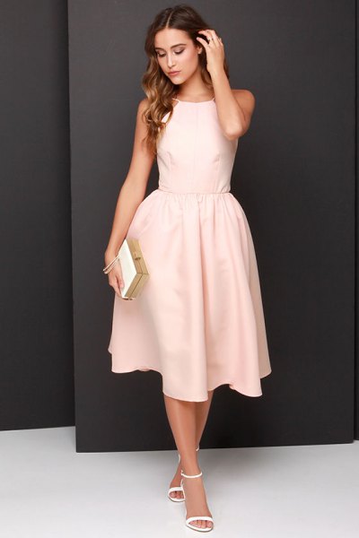 Light, peach-colored fit and flared sleeveless long dress