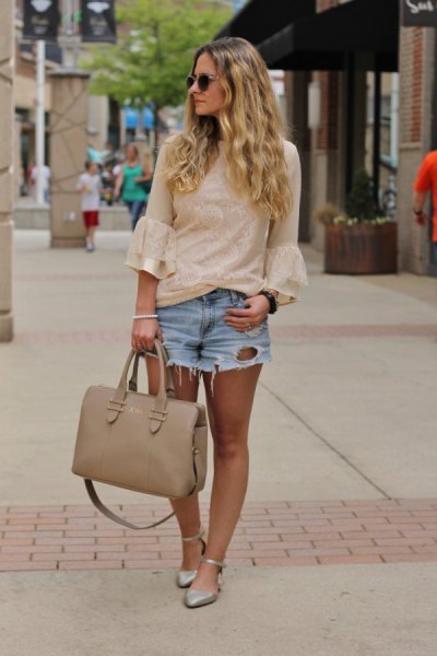 Light pink blouse with bell sleeves and blue denim shorts