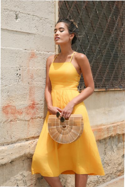 light yellow fit and a flared halter neck chiffon dress