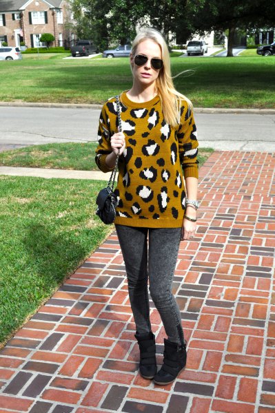 Lime green and black printed knitted sweater with gray leggings and wedge shoes
