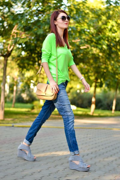 Lime green buttonless shirt with slim fit jeans with blue cuffs