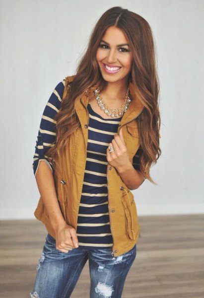 Lime green hooded vest with dark blue and pink striped T-shirt and ripped jeans