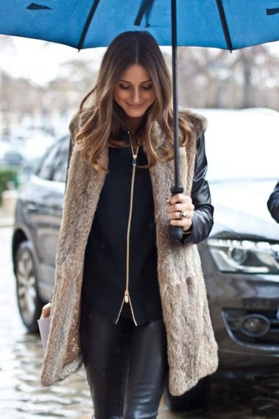 long light brown vest with black biker jacket and leather gaiters