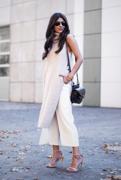 gray sleeveless tunic top with a long line and white, cropped pants with wide legs