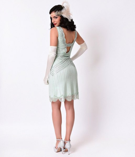 Flapper dress with a low back and white heels