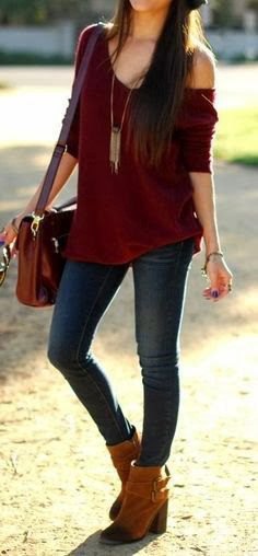 Maroon one shoulder sweater with a relaxed fit and a long, boho style necklace