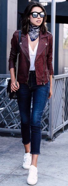 Moto jacket with white blouse with V-neck and short jeans