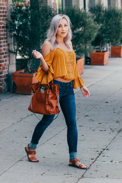 Mustard off the shoulder-free top with ruffled sleeves and blue skinny jeans