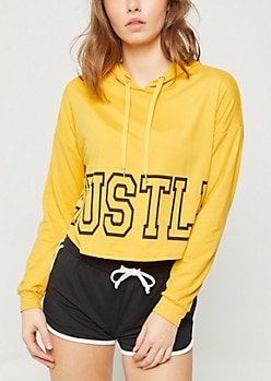 Mustard print hoodie and black mini running shorts