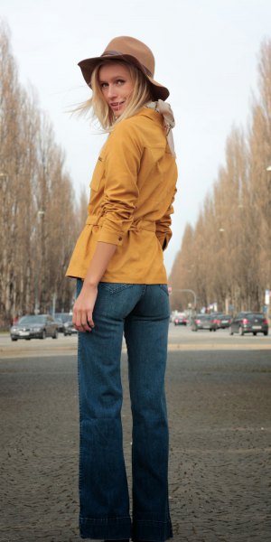 Mustard yellow suede shirt with belt and blue flared jeans