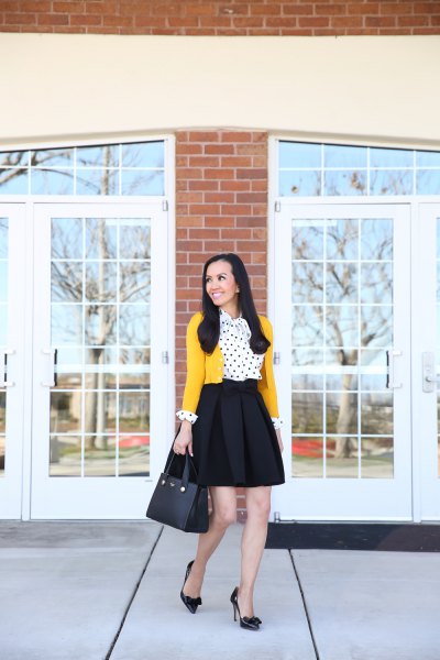 Mustard yellow cropped cardigan with white and black polka dot blouse