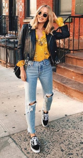 Mustard yellow blouse with a floral pattern and black leather biker jacket