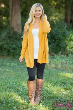 Mustard yellow longline pullover jacket with brown knee-high leather boots
