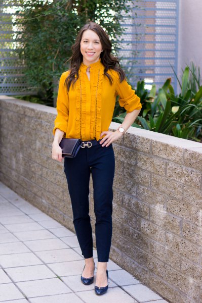 Mustard-yellow frilled mid-blouse with black chinos