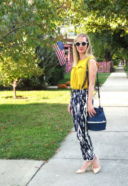 Mustard yellow sleeveless top with black and white printed pants with a relaxed fit