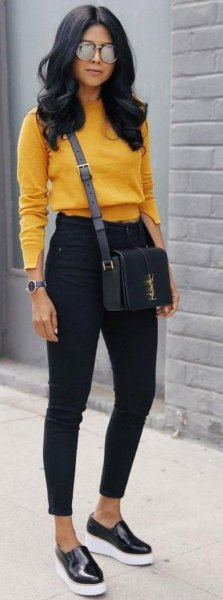 Mustard yellow, slightly cropped sweater with black ankle jeans