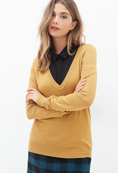 Mustard yellow V-neck sweater and black shirt with buttons