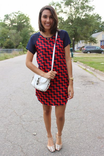 Mini dress with dark blue and red zigzag print and silver strappy sandals