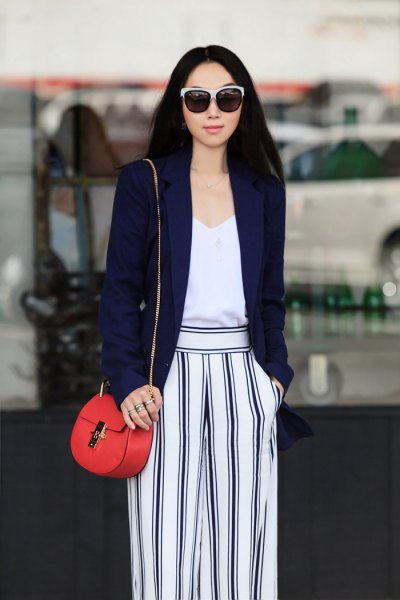 Navy blazer with white vest top and striped wide-leg pants