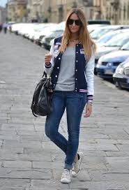 Dark blue and white college jacket with low sneakers