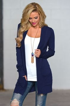 Dark blue cardigan with a white top with a scoop neckline and a boho necklace