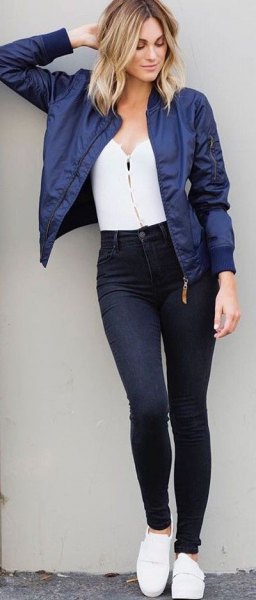 Dark blue, short cut bomber jacket with a white top