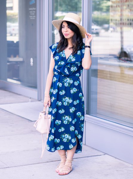 Dark blue midi dress with a V-neckline and floral pattern and strappy sandals