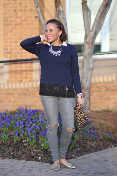 Dark blue fringed sweater with gray jeans