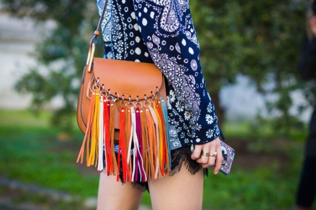 Dark blue, long-sleeved tribal mini dress with tribal print and brown leather wallet with fringes