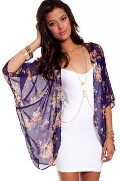 Dark blue, sheer cape with a floral pattern and white mini dress