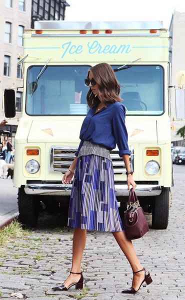 Navy blue shirt with a printed midi skirt and black heels