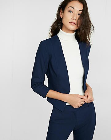 Dark blue slim fit blazer with a white sweater with a false neckline