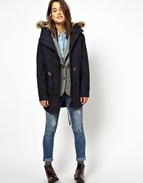 Parka coat with dark blue fur, gray vest and jeans
