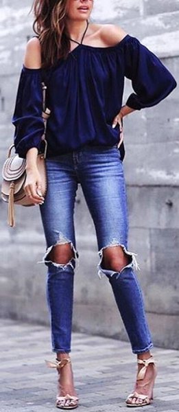 Off-the-shoulder navy blouse with ripped skinny jeans